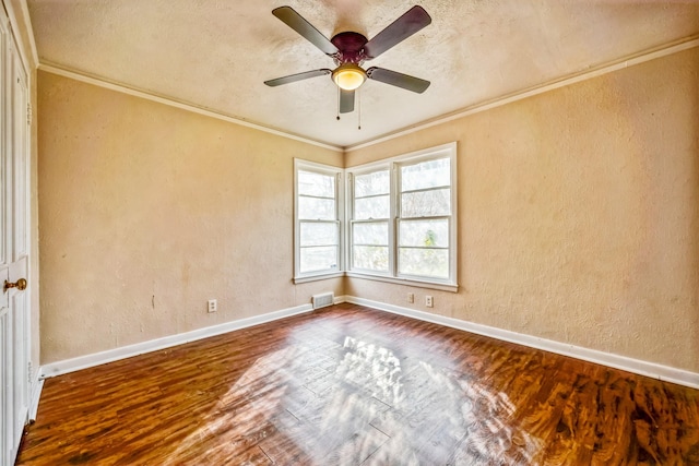 empty room with hardwood / wood-style floors, ceiling fan, and crown molding