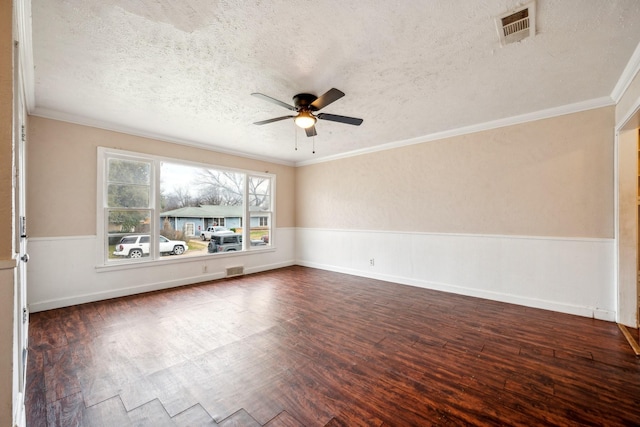 unfurnished room with ornamental molding, a textured ceiling, ceiling fan, and dark wood-type flooring