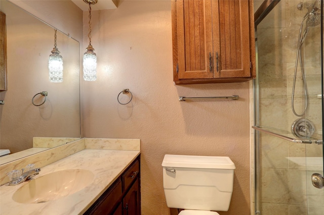 bathroom with vanity, toilet, and an enclosed shower