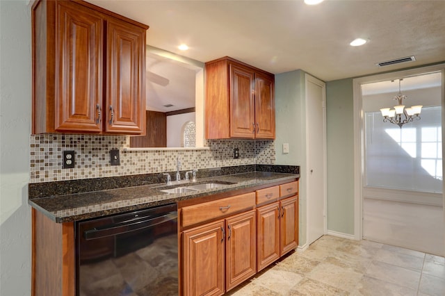 kitchen with sink, black dishwasher, a notable chandelier, backsplash, and dark stone countertops