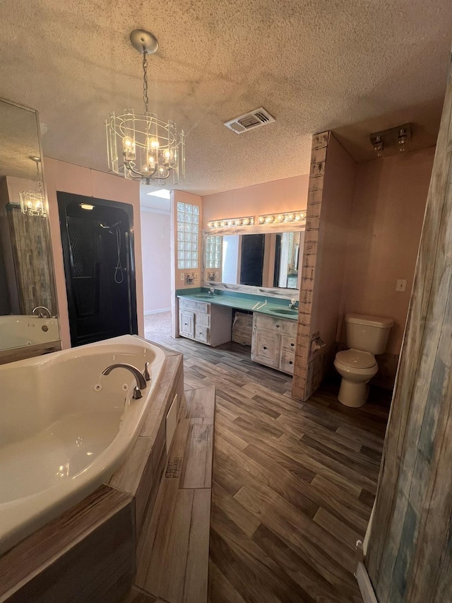 bathroom with wood-type flooring, vanity, a textured ceiling, and an inviting chandelier