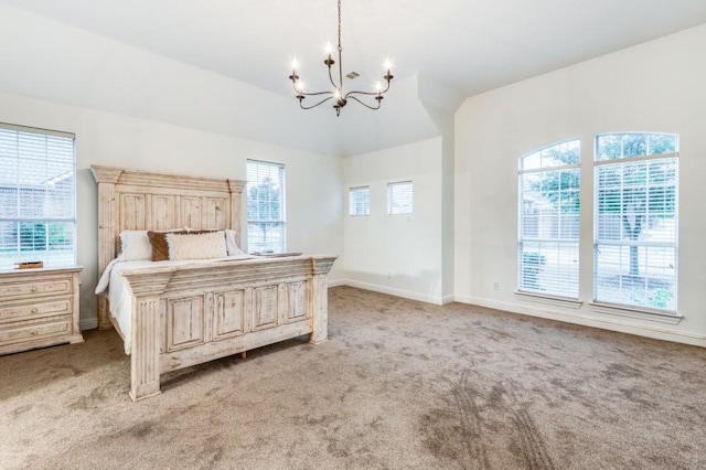 bedroom featuring light colored carpet, multiple windows, and a chandelier