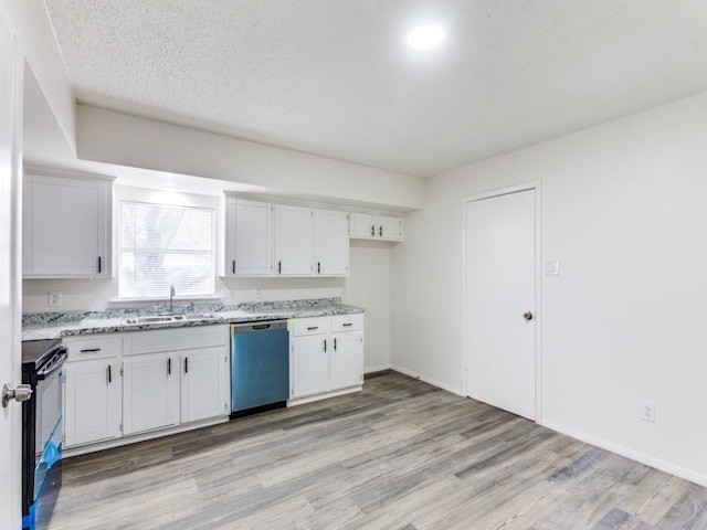 kitchen featuring dishwasher, black range oven, sink, white cabinets, and light wood-type flooring