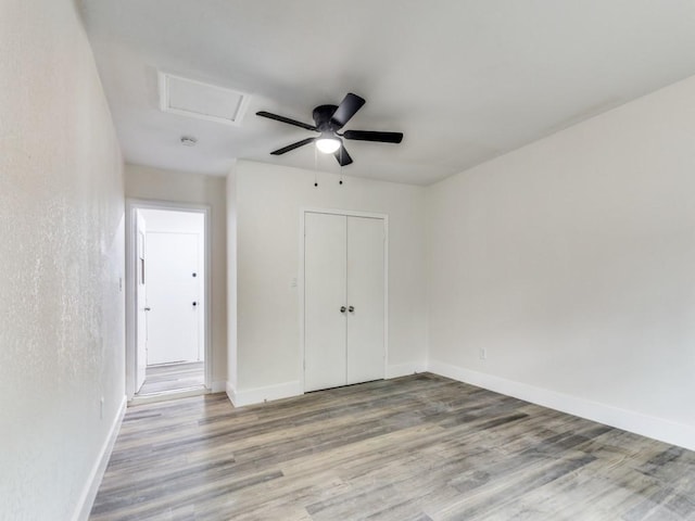 unfurnished bedroom with hardwood / wood-style floors, ceiling fan, and a closet