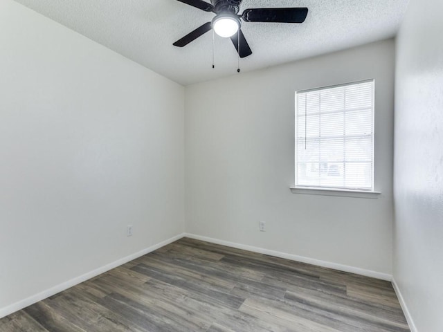 empty room featuring ceiling fan, dark hardwood / wood-style flooring, and a textured ceiling