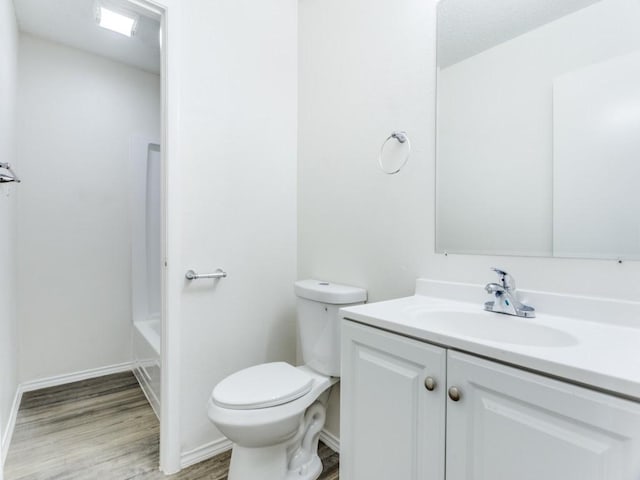 bathroom featuring vanity, wood-type flooring, and toilet