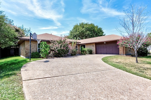 ranch-style home featuring a garage and a front lawn