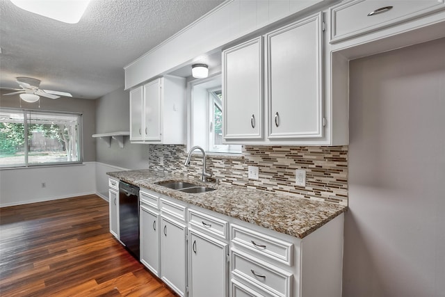 kitchen with dishwasher, white cabinetry, and sink