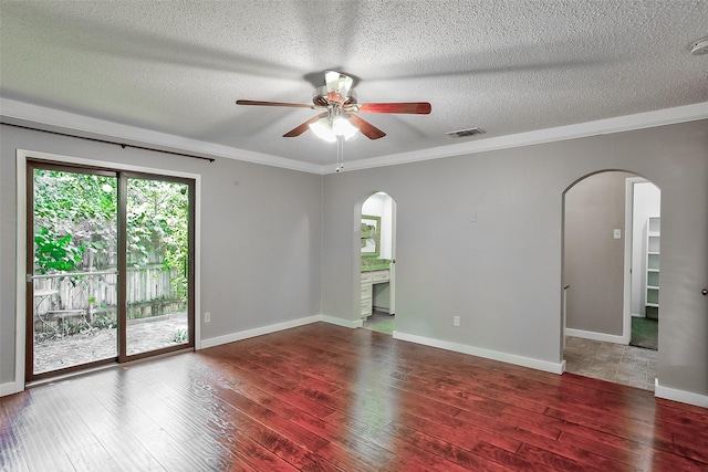 empty room featuring ceiling fan, ornamental molding, wood-type flooring, and a textured ceiling