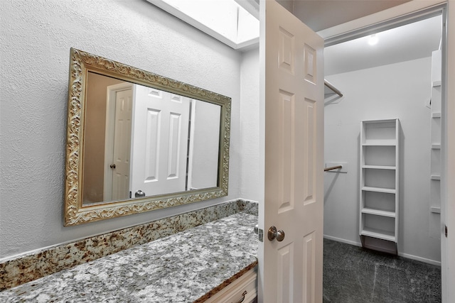 bathroom featuring vanity and a skylight