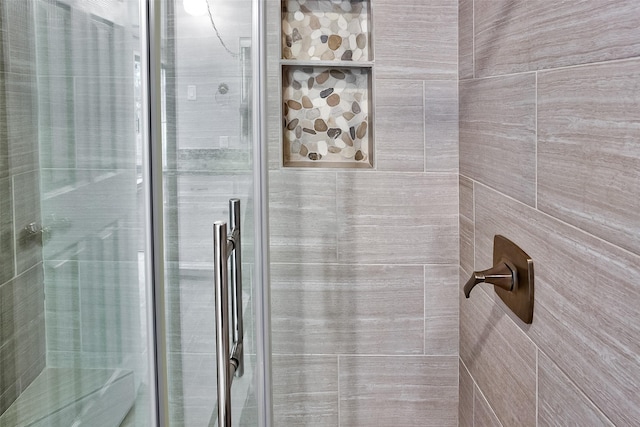 bathroom with a shower with shower door