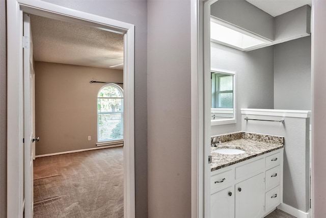 bathroom with vanity and a textured ceiling