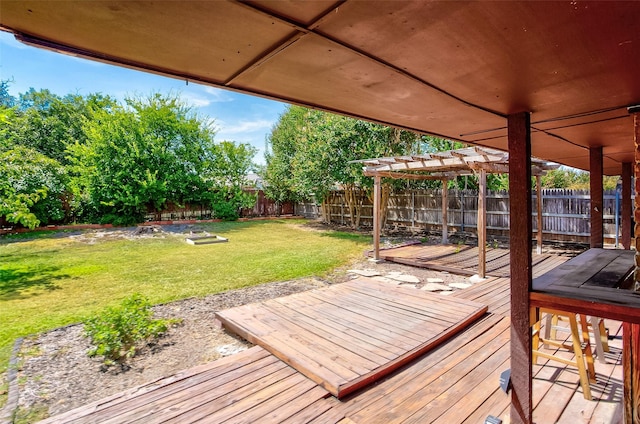 wooden terrace featuring a pergola and a yard