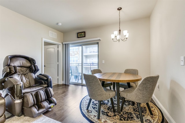 dining area featuring dark hardwood / wood-style floors and a chandelier