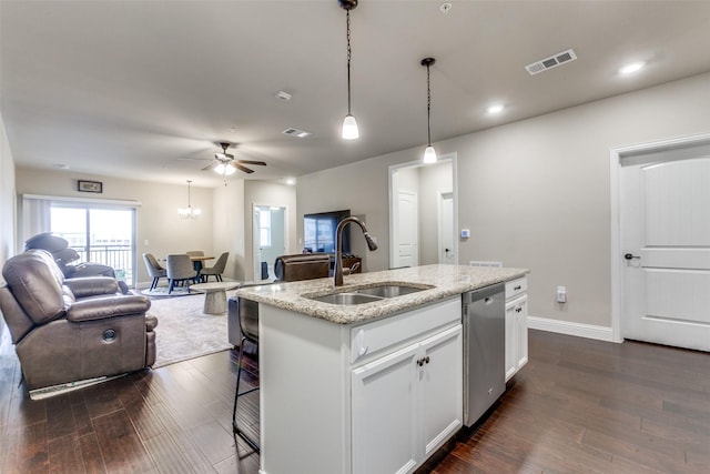 kitchen featuring a center island with sink, dishwasher, white cabinets, and sink