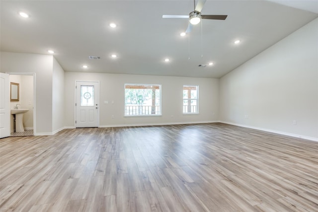 unfurnished living room with ceiling fan, light hardwood / wood-style floors, plenty of natural light, and sink