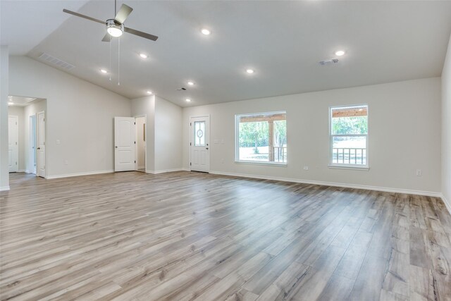 unfurnished living room with high vaulted ceiling, a wealth of natural light, ceiling fan, and light hardwood / wood-style flooring