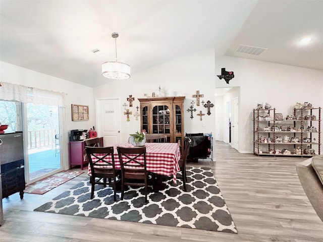 407 W Saunders St, Trenton, TX 75490 - dining area with wood finished floors, baseboards, a chandelier, and high vaulted ceiling