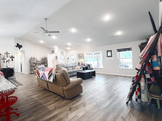 living room with ceiling fan, vaulted ceiling, and hardwood / wood-style flooring