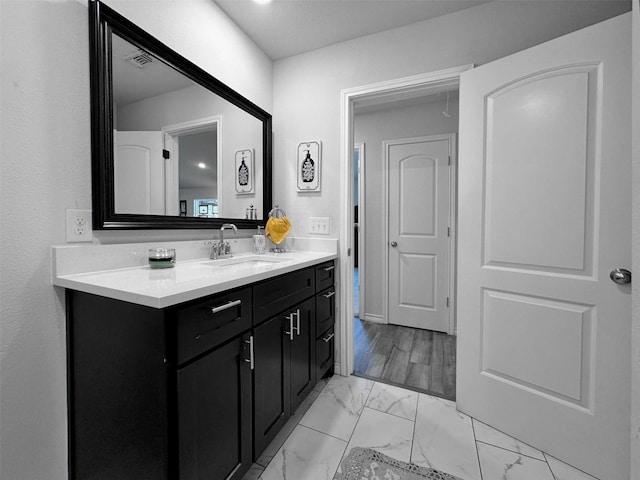 407 W Saunders St, Trenton, TX 75490 - bathroom featuring marble look tile flooring and vanity