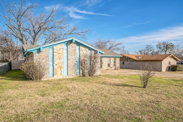 view of home's exterior with a patio area and a yard