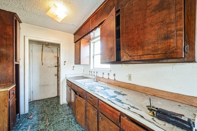 kitchen with sink and a textured ceiling