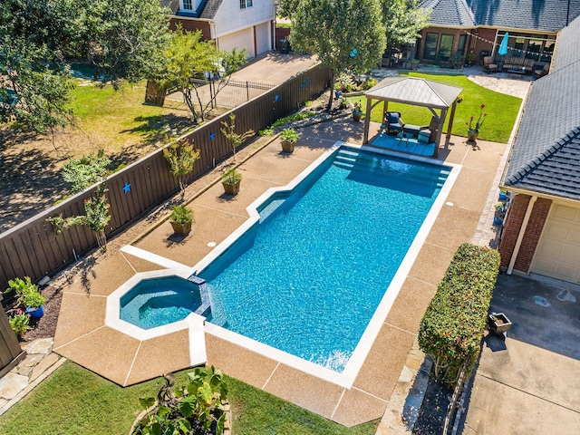 view of swimming pool featuring a fenced backyard, a pool with connected hot tub, a patio, and a gazebo