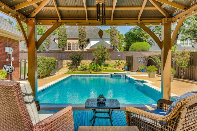 view of pool with a gazebo, a fenced backyard, a pool with connected hot tub, and a patio area