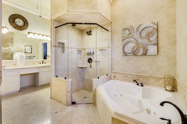 bathroom with a tub with jets, a shower stall, and vanity