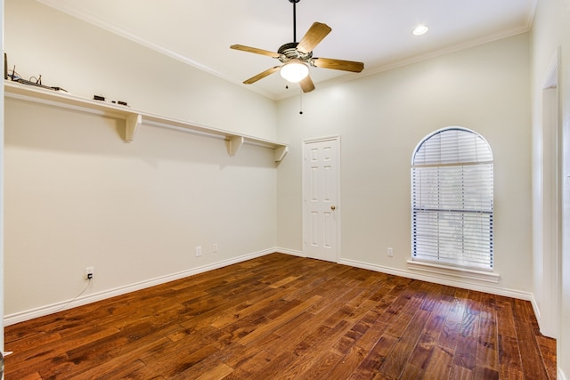 empty room featuring crown molding, ceiling fan, wood finished floors, and baseboards