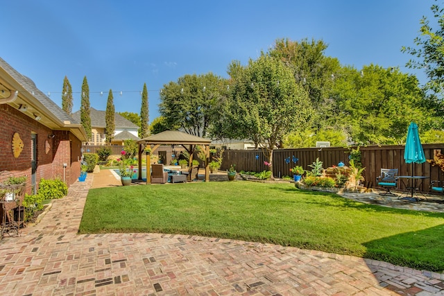 view of yard featuring a gazebo, a patio, a fenced backyard, and an outdoor hangout area