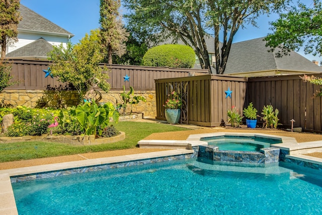 view of swimming pool featuring a fenced backyard and a pool with connected hot tub