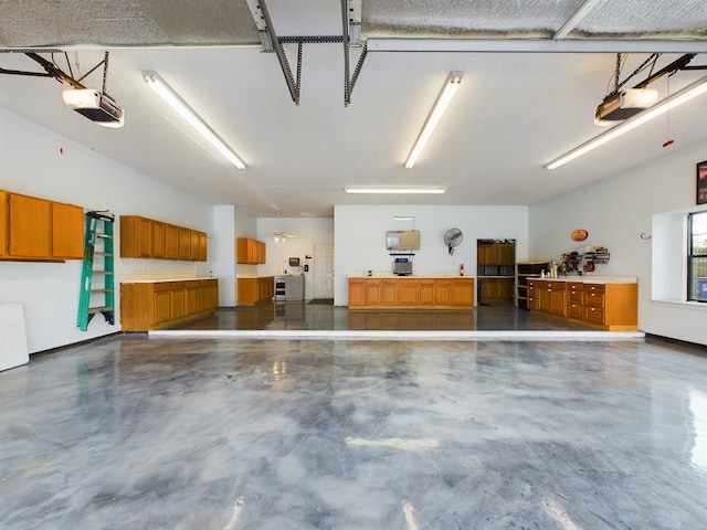 garage with ceiling fan and a garage door opener