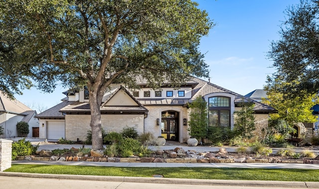 view of front facade featuring french doors and a garage