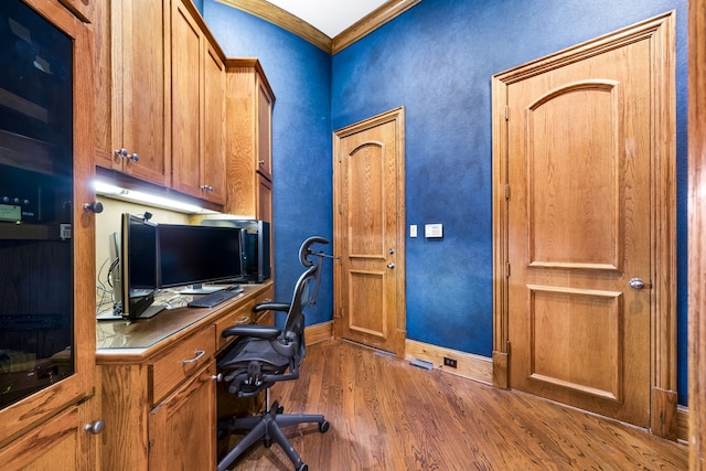 home office featuring ornamental molding and dark wood-type flooring