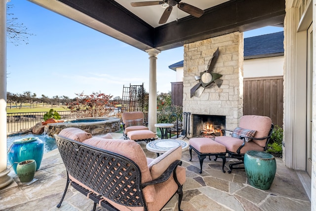 view of patio / terrace with a fenced in pool, pool water feature, and an outdoor stone fireplace