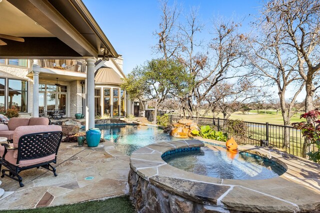 view of pool with a patio area, ceiling fan, and an in ground hot tub