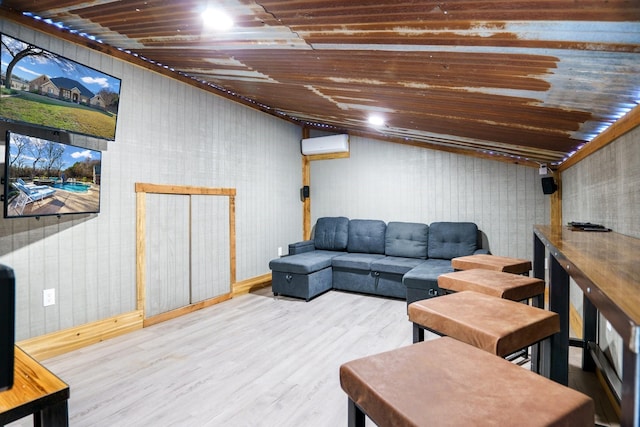 living room with hardwood / wood-style floors and a wall mounted AC