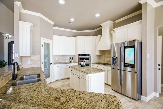 kitchen featuring sink, stainless steel appliances, light stone counters, backsplash, and premium range hood