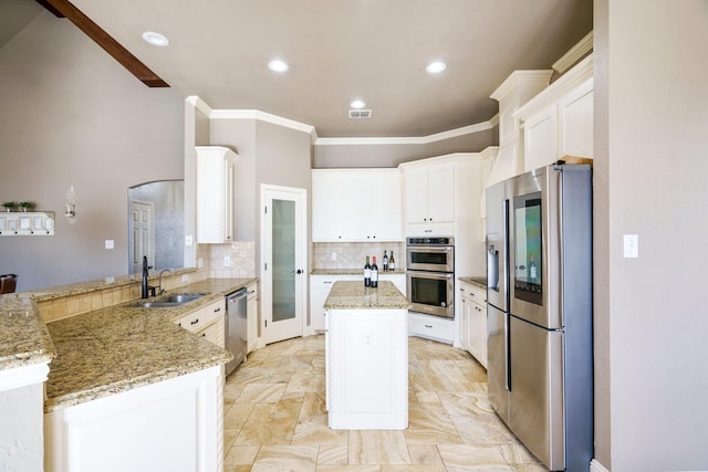 kitchen with white cabinetry, kitchen peninsula, sink, and appliances with stainless steel finishes