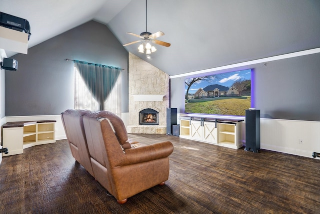 living room with ceiling fan, a fireplace, lofted ceiling, and hardwood / wood-style flooring