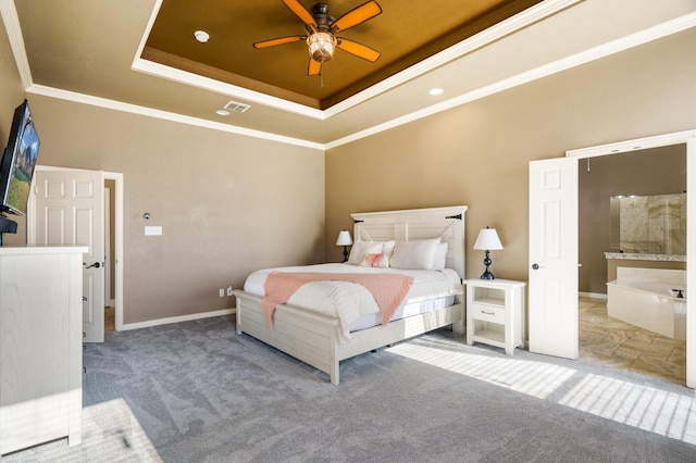 carpeted bedroom with a tray ceiling, ceiling fan, and crown molding