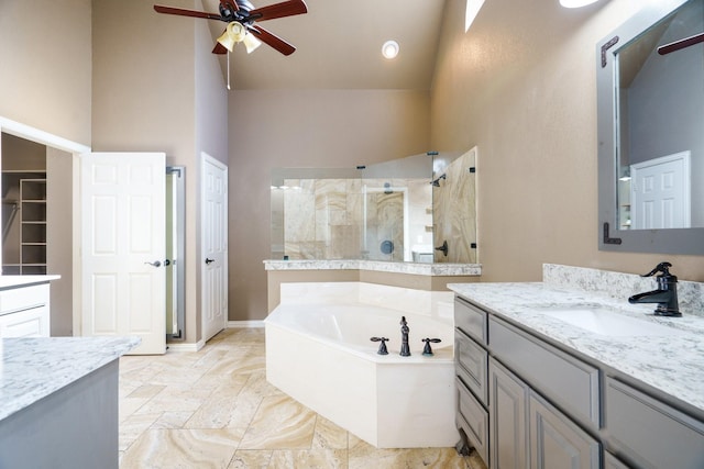 bathroom with vanity, high vaulted ceiling, ceiling fan, and independent shower and bath