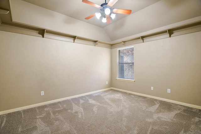 carpeted empty room featuring ceiling fan and lofted ceiling