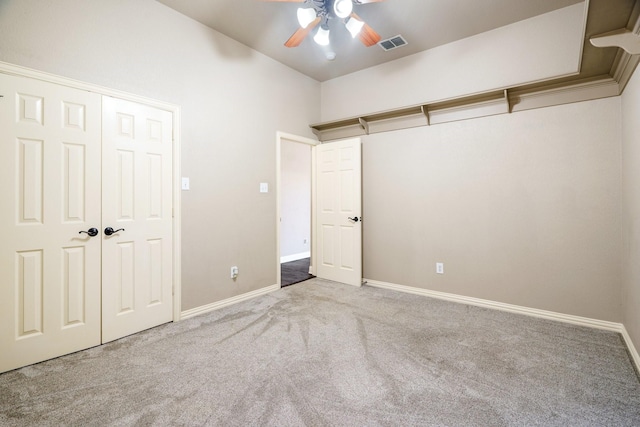 unfurnished bedroom with light carpet, a closet, and ceiling fan