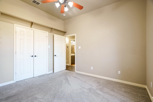 unfurnished bedroom with ceiling fan and carpet floors