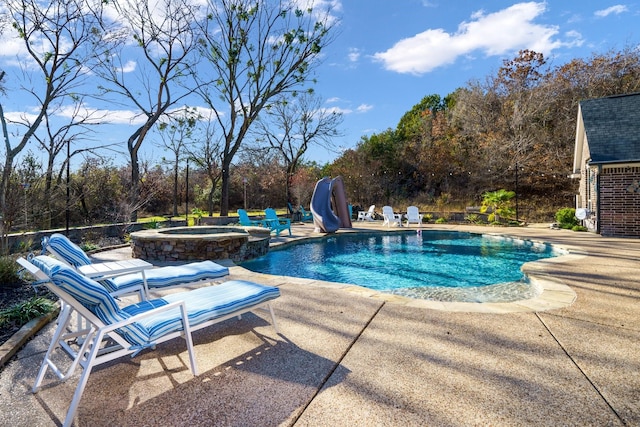 view of swimming pool with an in ground hot tub, a patio area, and a water slide