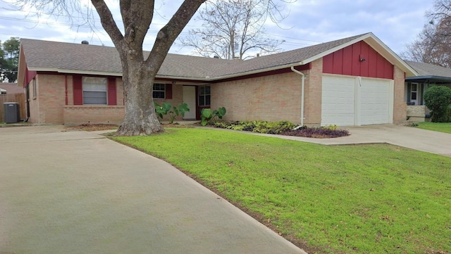 ranch-style house with a front yard, central AC, and a garage