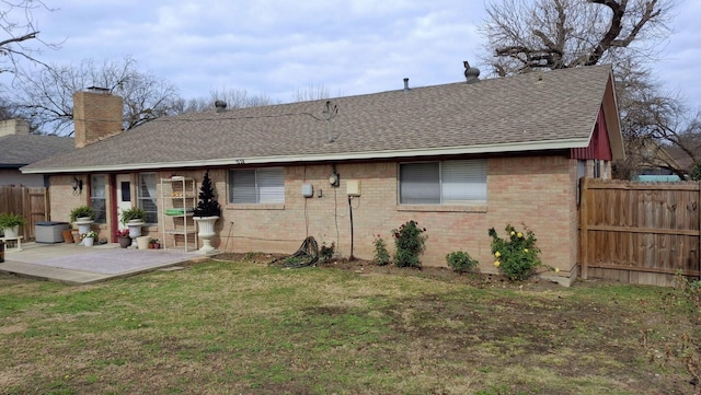 back of property featuring a patio area and a yard