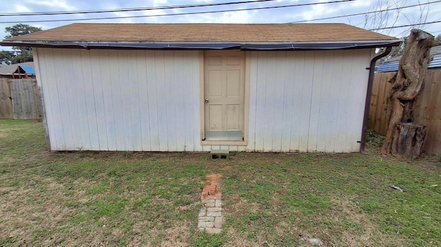 view of outdoor structure featuring a lawn